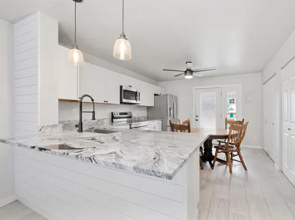 a view of dining table chairs and chandelier