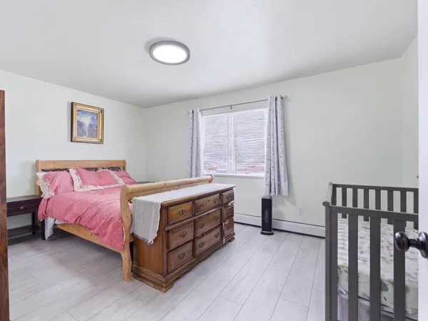 a bed room with a bed and a chair