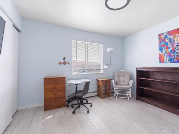 a view of a workspace with furniture and a window