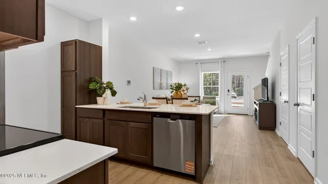 a kitchen with stainless steel appliances a sink stove and refrigerator