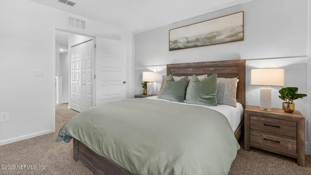 a bedroom with a bed and a painting on the wall