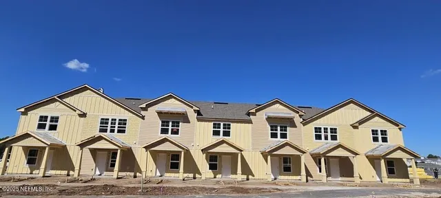 a view of residential houses with cars parked
