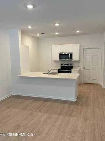 a bedroom with a bed and painting on the wall