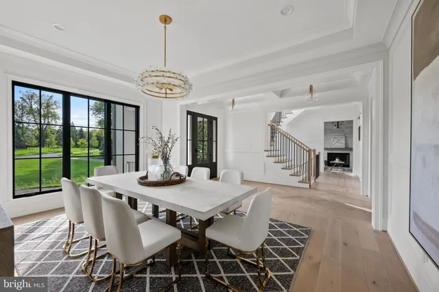 a view of a hallway with furniture and windows