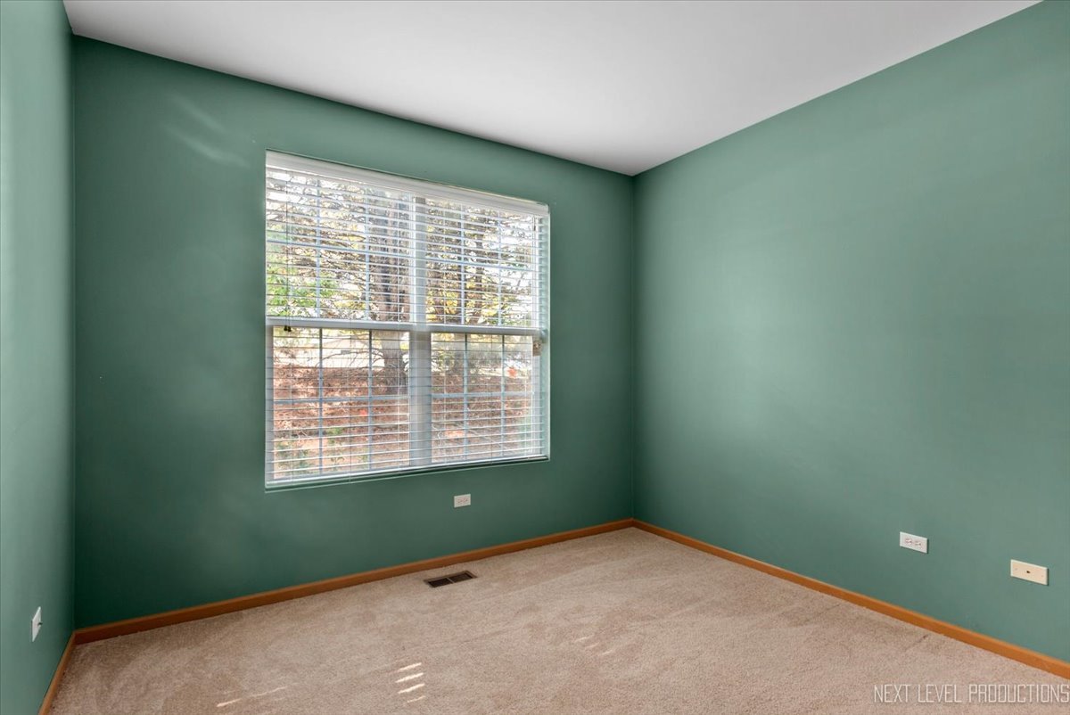 611 Waterview Court, Unit 611 Naperville, IL 60563 - Photo 11 of 16 a view of an empty room with a window
