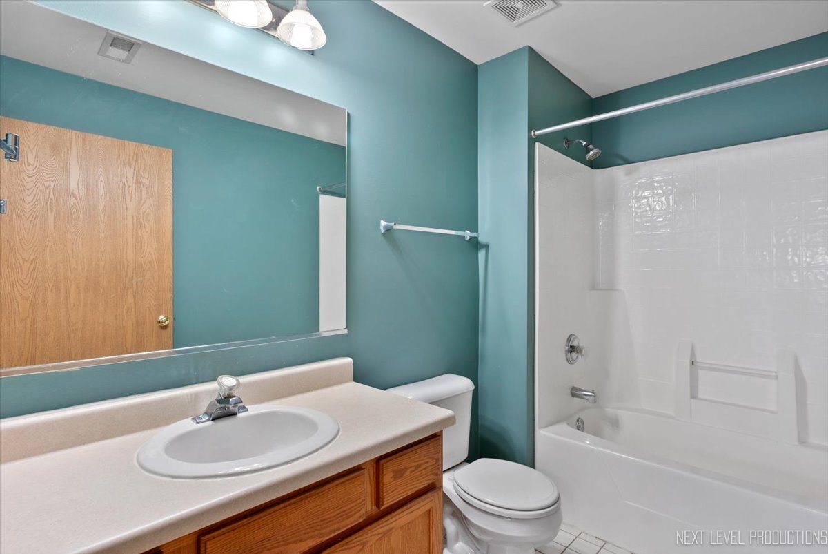 611 Waterview Court, Unit 611 Naperville, IL 60563 - Photo 15 of 16 a bathroom with a sink toilet and shower