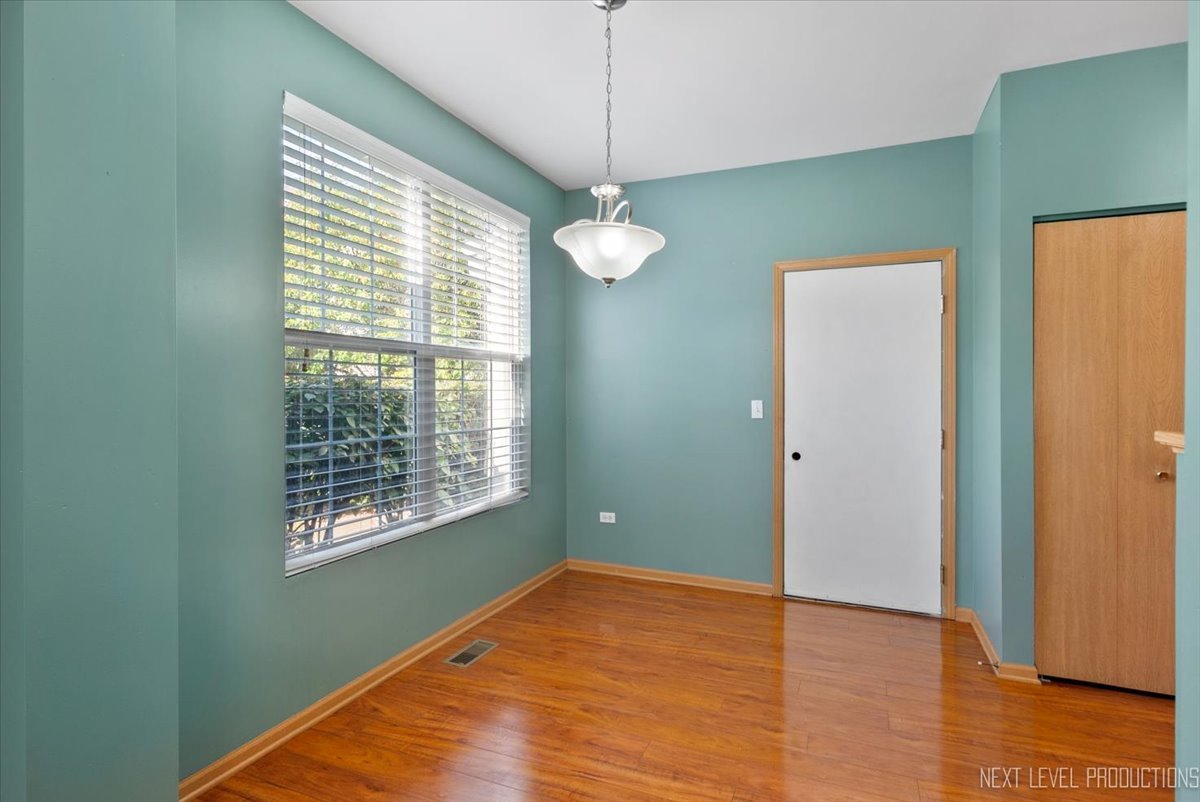 611 Waterview Court, Unit 611 Naperville, IL 60563 - Photo 5 of 16 a view of empty room with wooden floor and fan