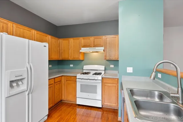a kitchen with a refrigerator sink and stove