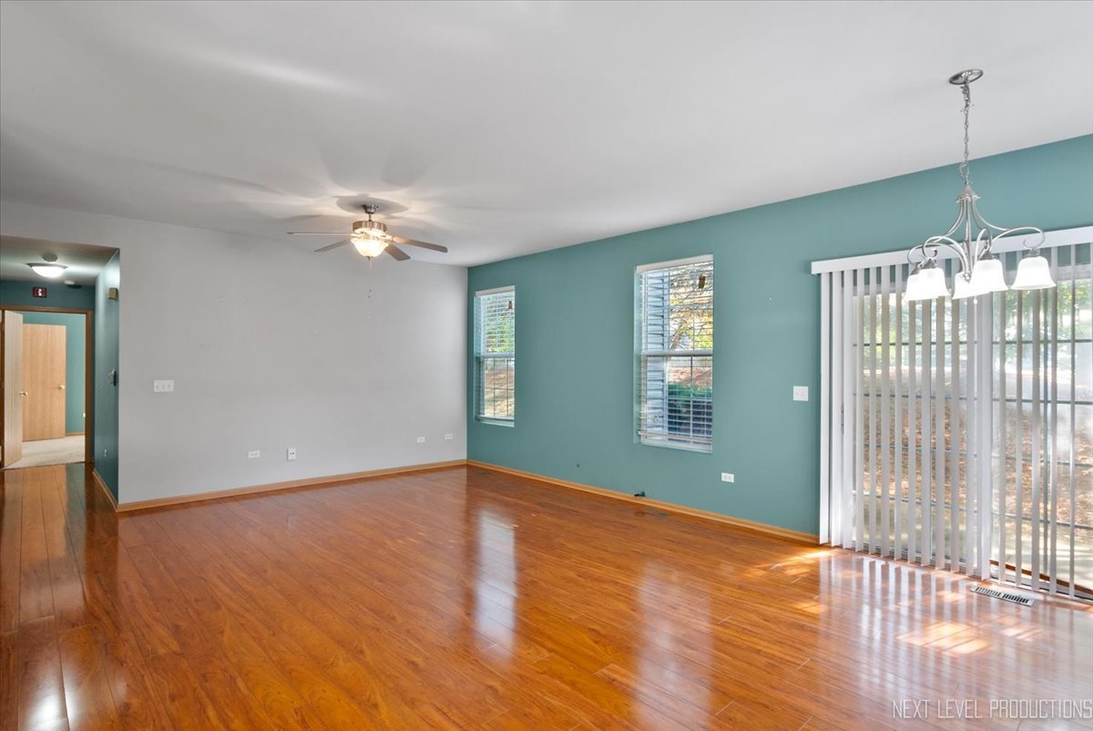 611 Waterview Court, Unit 611 Naperville, IL 60563 - Photo 8 of 16 a view of an empty room with wooden floor and fan