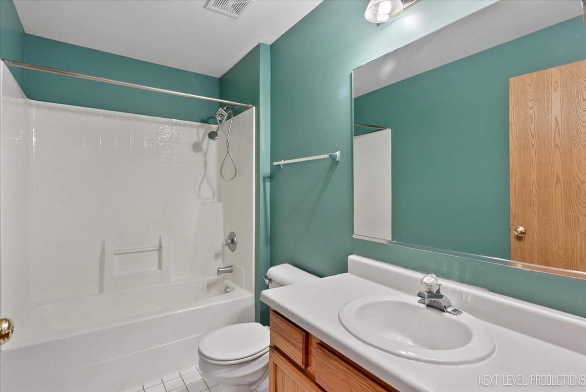 611 Waterview Court, Unit 611 Naperville, IL 60563 - Photo 10 of 16 a bathroom with a sink toilet and shower