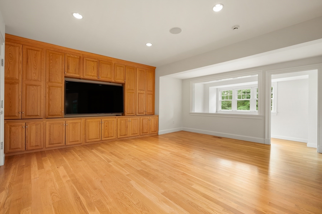 10 Wilson's Way Dover, MA 02030 - Photo 19 of 42 a view of an empty room with wooden floor and a window