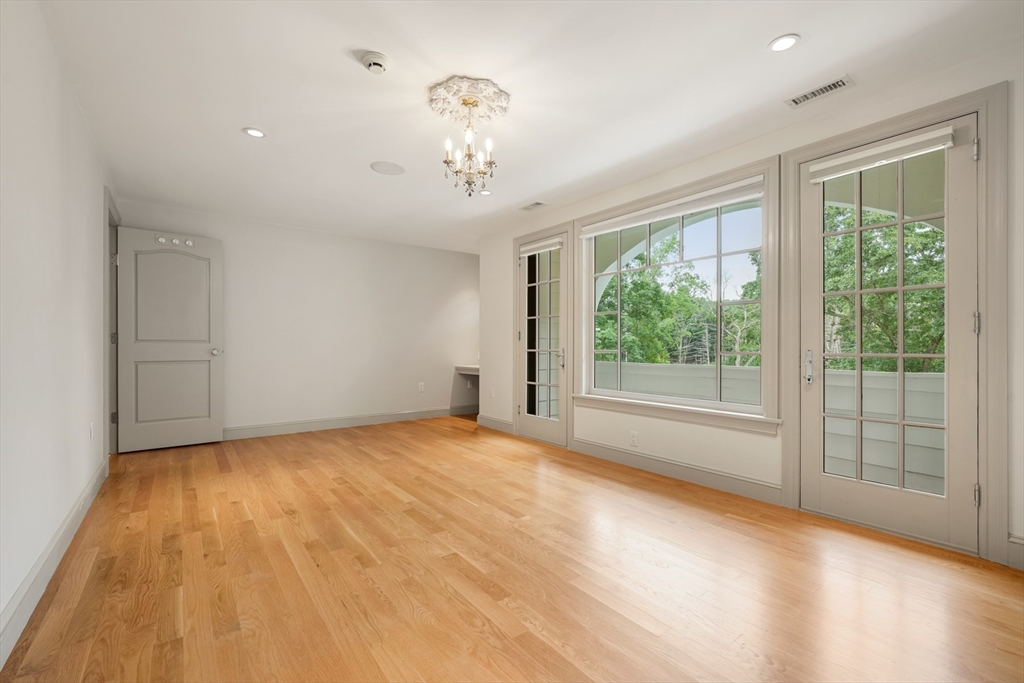10 Wilson's Way Dover, MA 02030 - Photo 20 of 42 a view of an empty room with wooden floor and a window