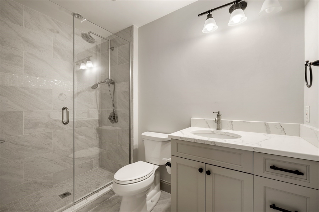 10 Wilson's Way Dover, MA 02030 - Photo 21 of 42 a bathroom with a sink toilet vanity and shower