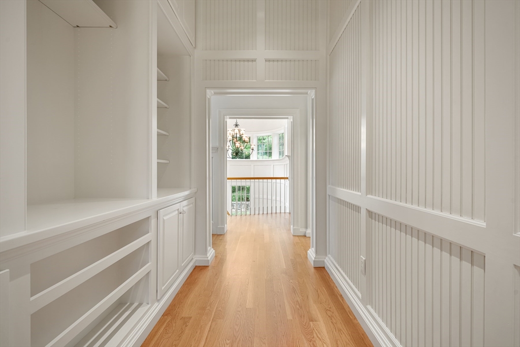 10 Wilson's Way Dover, MA 02030 - Photo 25 of 42 a view of a hallway with wooden floor and a bathroom