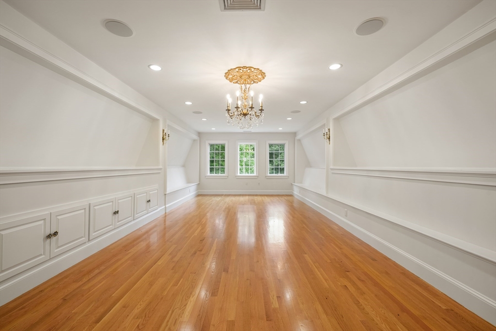 10 Wilson's Way Dover, MA 02030 - Photo 27 of 42 a view of an empty room with a window and wooden floor