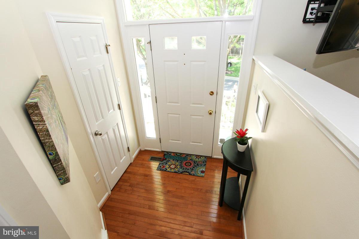 12666 Granite Ridge Drive North Potomac, MD 20878 - Photo 2 of 30 a view of a hallway with wooden floor and staircase