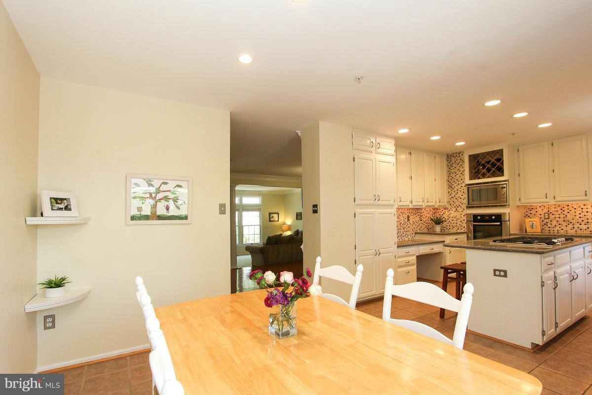 12666 Granite Ridge Drive North Potomac, MD 20878 - Photo 11 of 30 a room with stainless steel appliances kitchen island granite countertop a sink and cabinets
