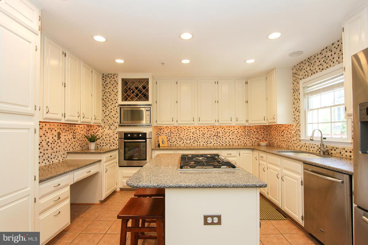 12666 Granite Ridge Drive North Potomac, MD 20878 - Photo 12 of 30 a kitchen with a stove a sink and a refrigerator