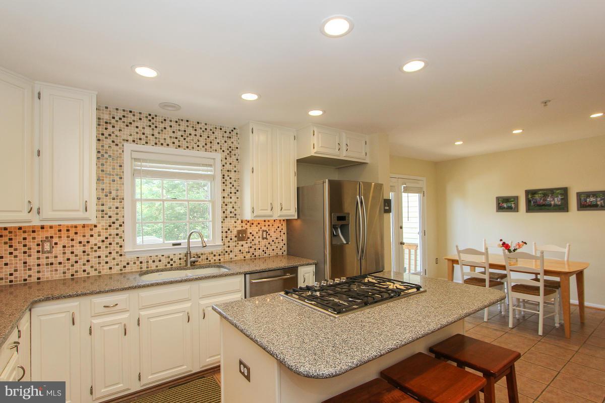12666 Granite Ridge Drive North Potomac, MD 20878 - Photo 14 of 30 a kitchen with a stove a sink and a refrigerator