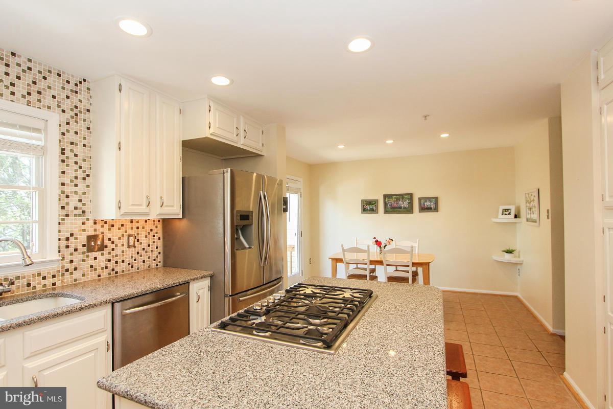 12666 Granite Ridge Drive North Potomac, MD 20878 - Photo 15 of 30 a large bedroom with a large bed a rug and chair