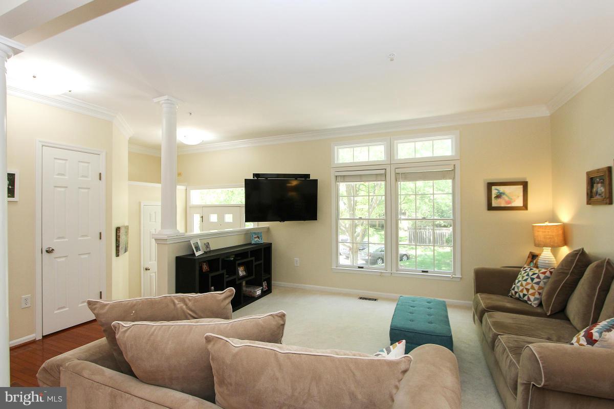 12666 Granite Ridge Drive North Potomac, MD 20878 - Photo 3 of 30 a living room with furniture and a flat screen tv
