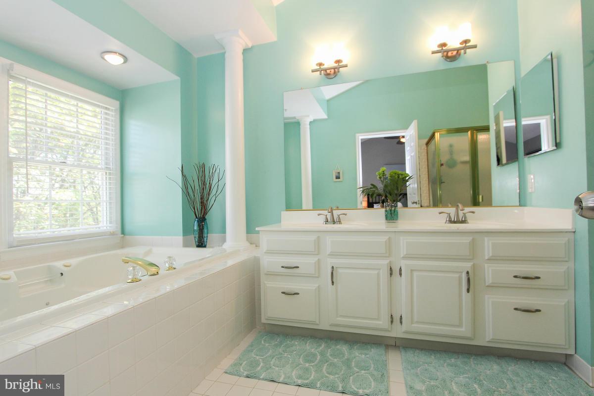 12666 Granite Ridge Drive North Potomac, MD 20878 - Photo 23 of 30 a spacious bathroom with a double vanity sink mirror and bathtub