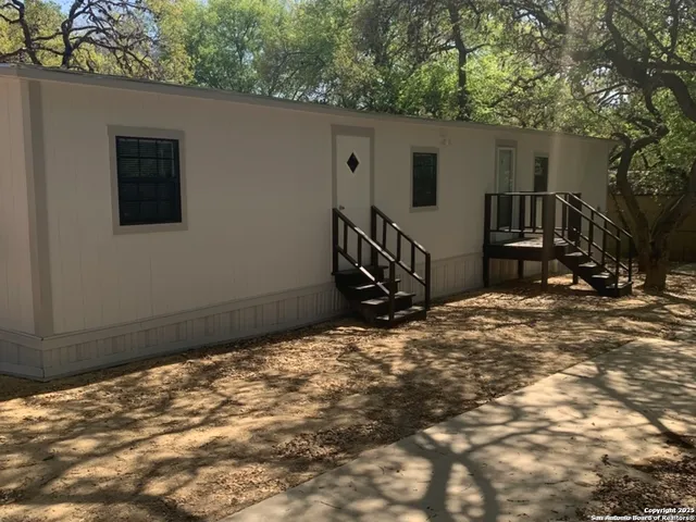 a backyard of a house with table and chairs