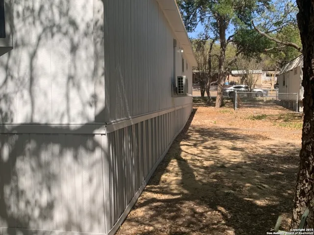 a view of a backyard with wooden fence