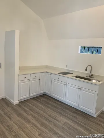 a view of a wooden house with a small yard