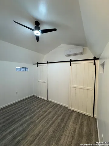 a bathroom with a toilet a sink a mirror and vanity