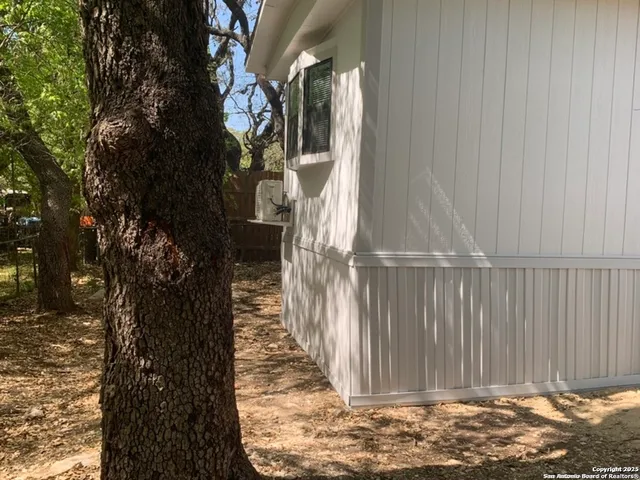 a view of a pathway of a house with wooden fence