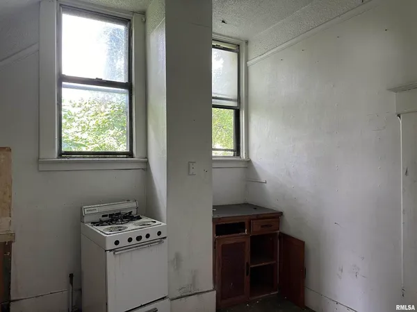 a bathroom with a toilet a sink and a window