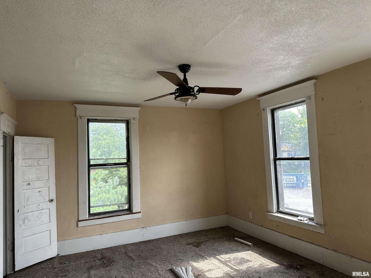 103 North 7th Street Murphysboro, IL 62966 - Photo 15 of 18 an empty room with windows and ceiling fan