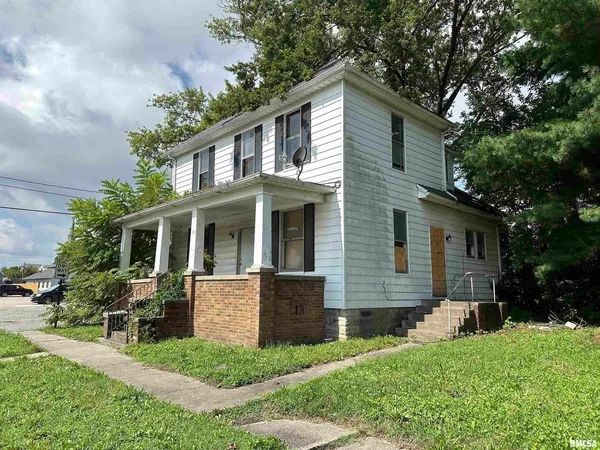 a front view of a house with a yard and porch