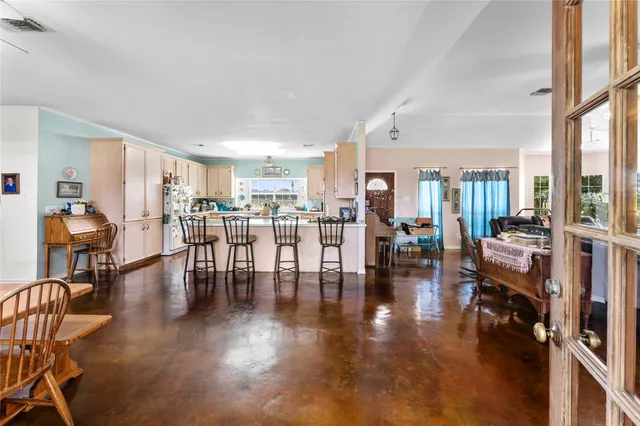 a living room with lots of furniture and wooden floor