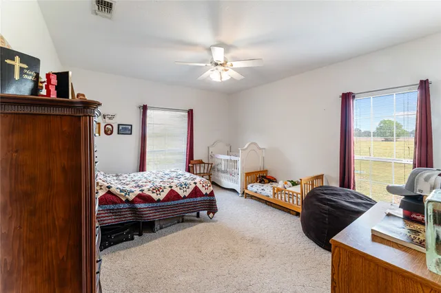 a bedroom with bed and a chandelier