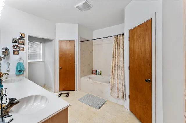 a en suite bathroom with a sink and a mirror