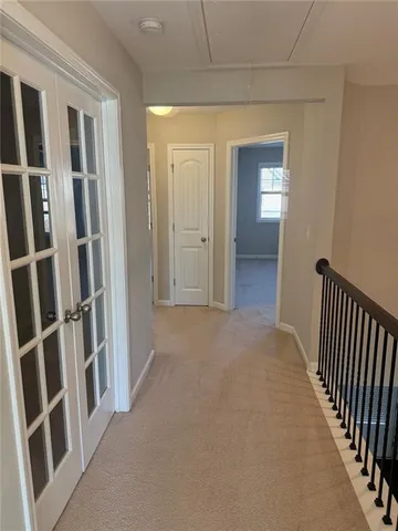 a view of a hallway with wooden floor and entryway