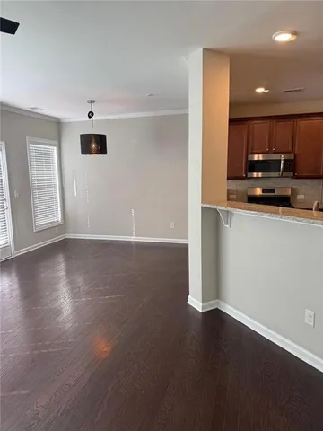 a view of a kitchen with a sink and a refrigerator