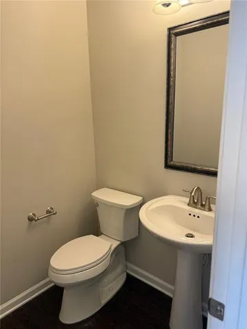 a white toilet sitting next to a bathroom sink