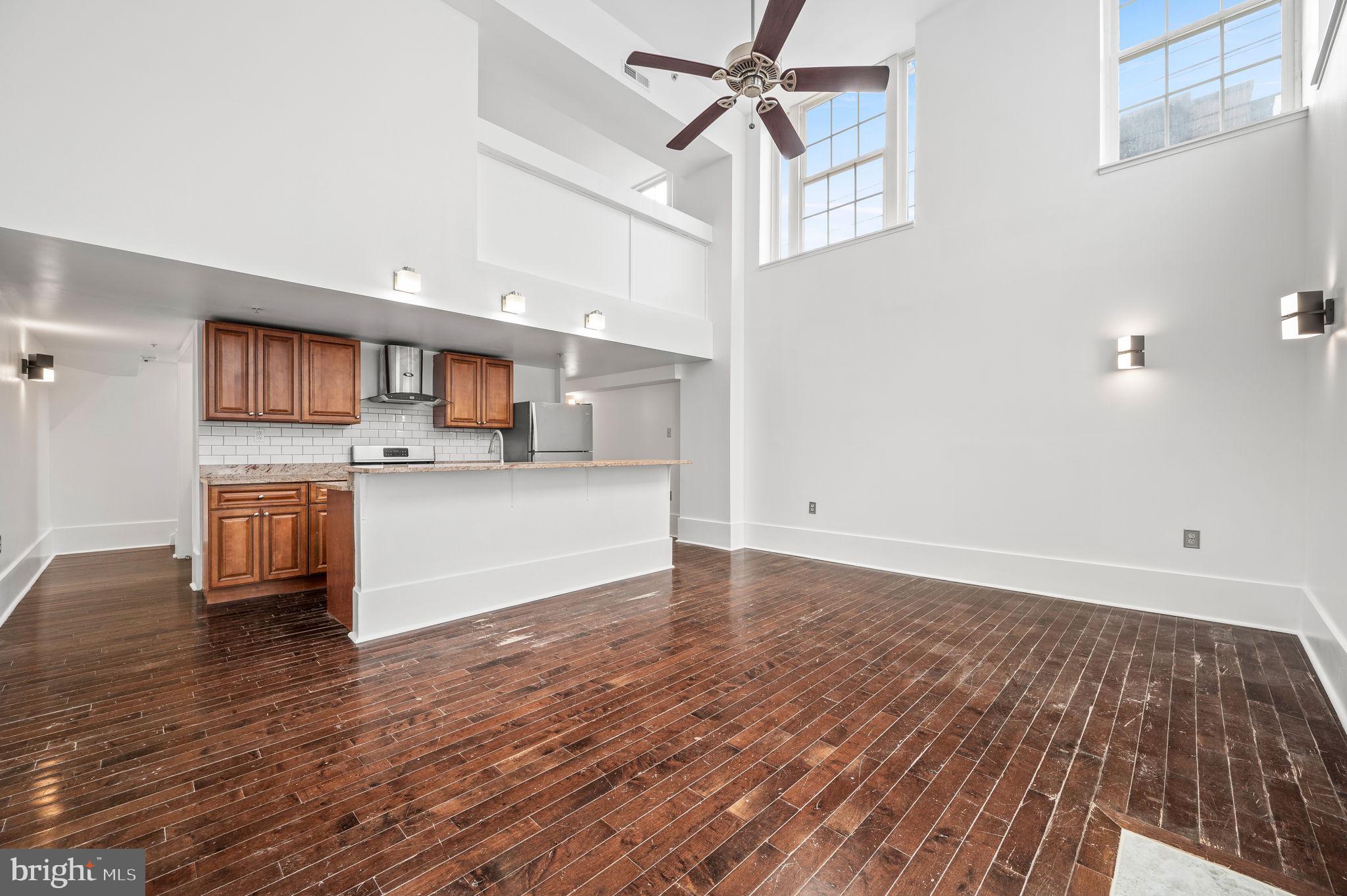 1201 South 5th Street, Unit B Philadelphia, PA 19147 - Photo 3 of 17 Living Room/Dining Room with 2-Story Ceilings