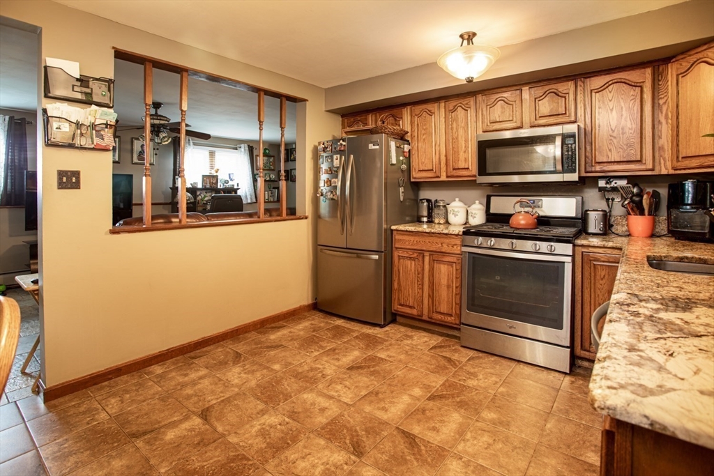 166 Stonehaven Road Fall River, MA 02723 - Photo 22 of 33 a kitchen with stainless steel appliances granite countertop a refrigerator stove top oven and sink