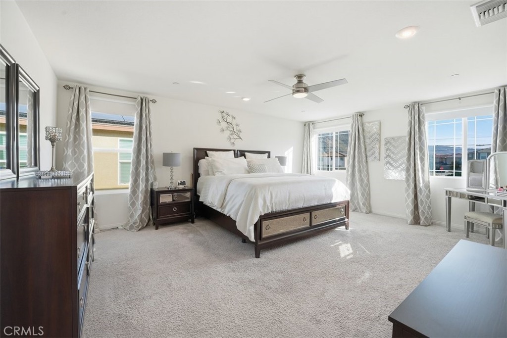 7608 Citrusmoon Court Riverside, CA 92507 - Photo 13 of 25 a bedroom with a bed a table and painting
