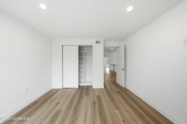 a view of a room with wooden floor and a sink