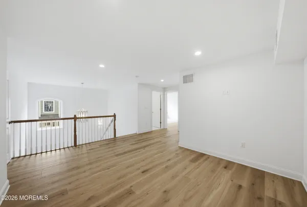 a view of a room with wooden floor