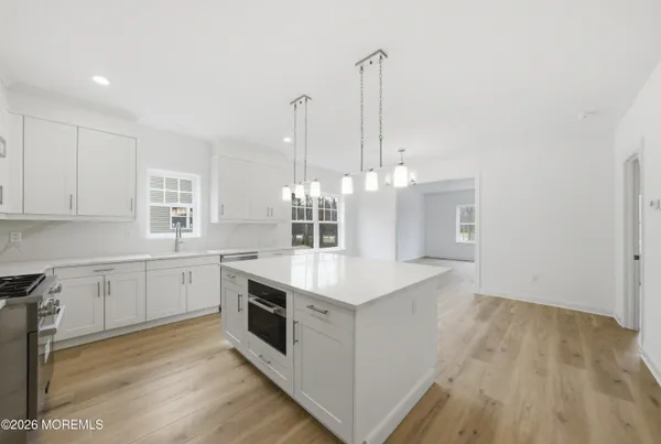 a kitchen with a sink stove and cabinets