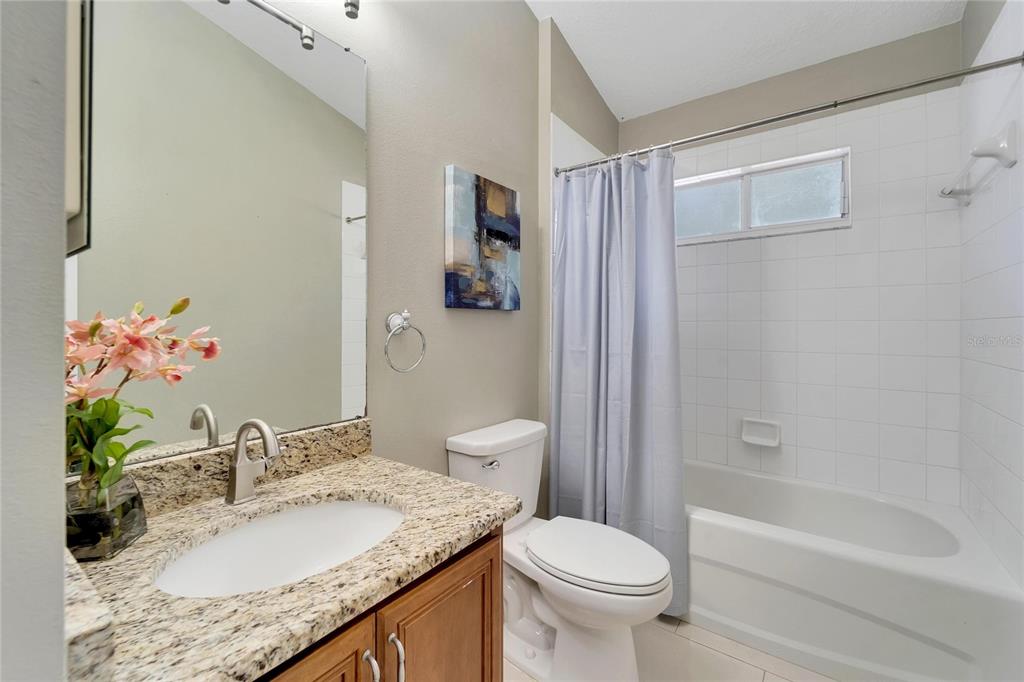 12739 Standbridge Drive Riverview, FL 33579 - Photo 17 of 38 a bathroom with a granite countertop sink toilet and shower