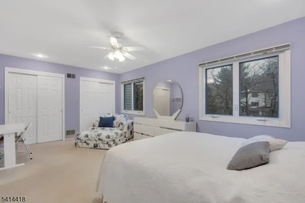 a bedroom with a large bed and a large window
