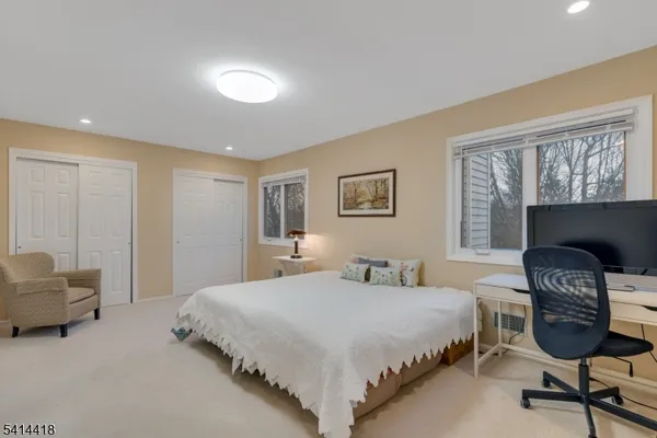 a bedroom with a bed chair and a window