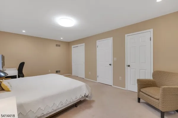 a bedroom with a large bed and a couch